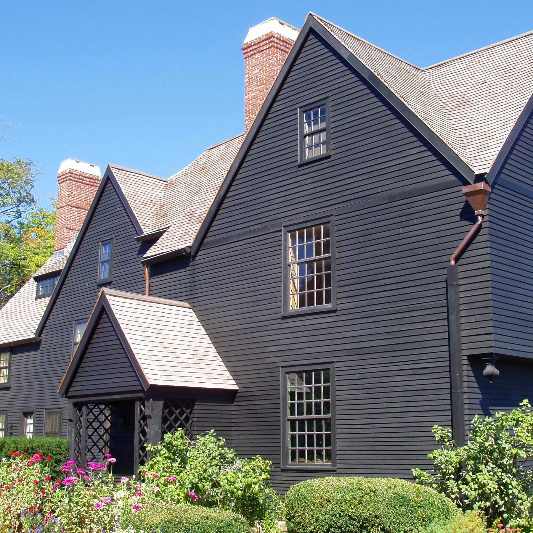 a dark grey house with peaked roof