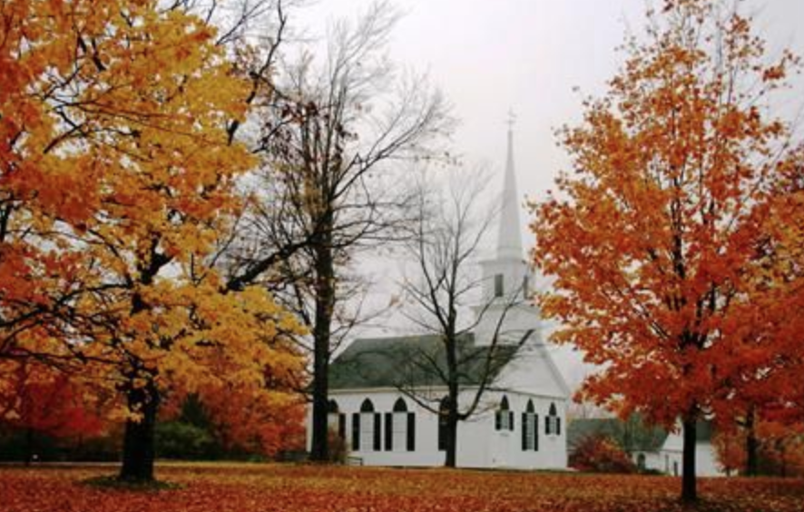a dark spooky building with large red indow at the front